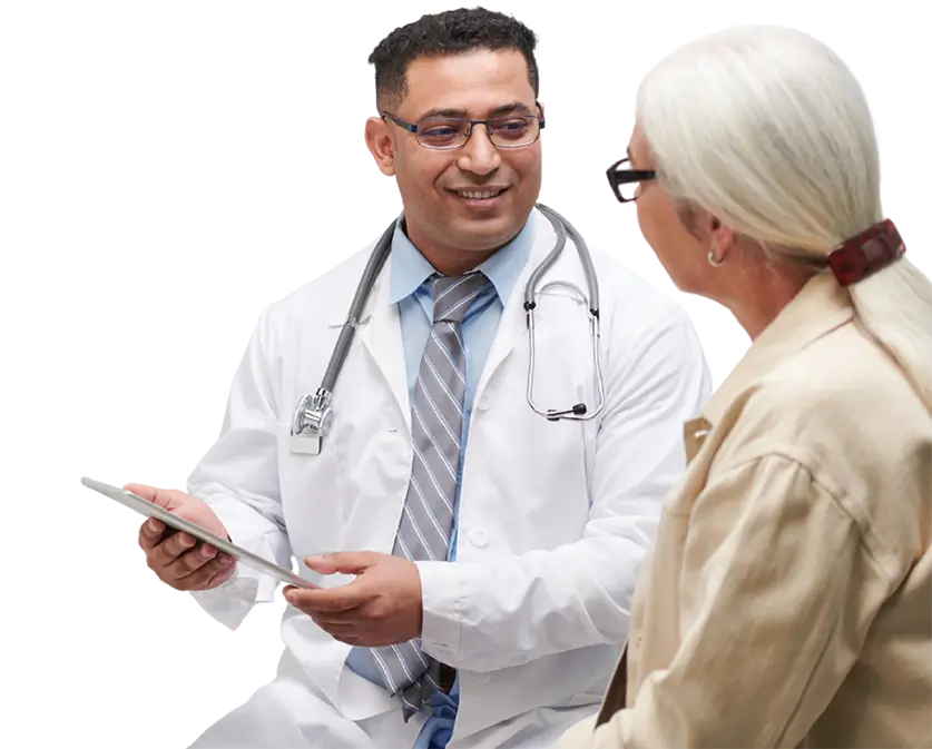 Doctor holding a tablet device while consulting with a patient