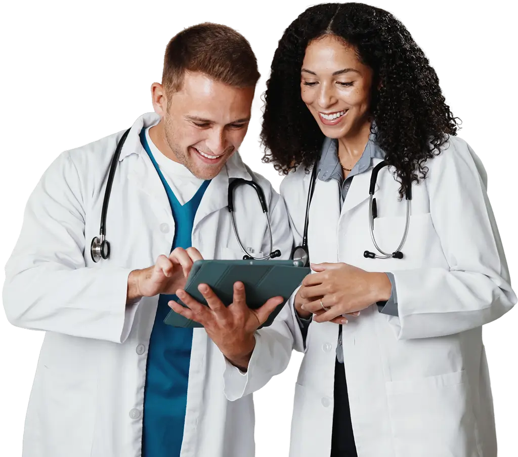 Two doctors examining a tablet computer together, discussing patient information or medical data.`
