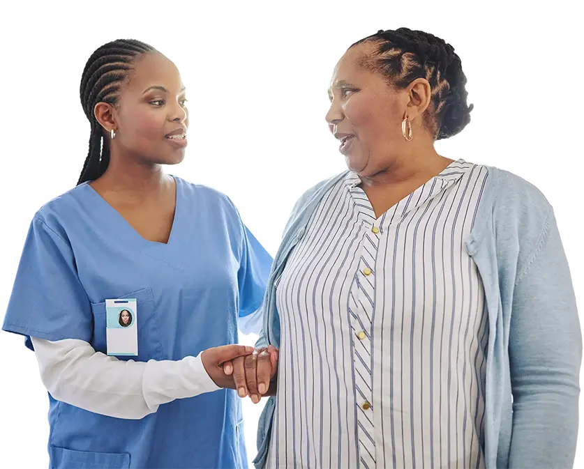 Two women in scrubs engaged in conversation, sharing information in a healthcare setting.
